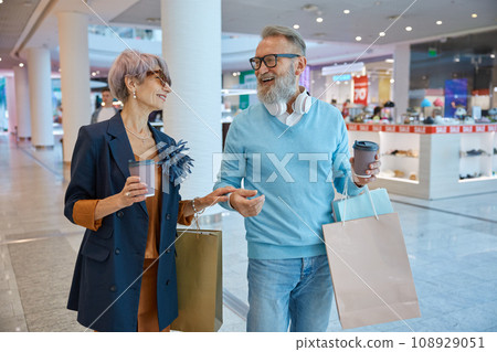 Fashionable elderly couple enjoying shopping tour on black friday weekends Fashionable elderly couple enjoying shopping tour on black friday weekends 108929051