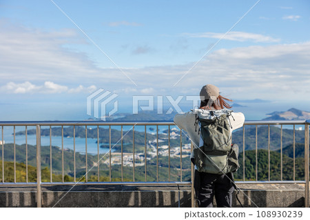 A woman climbing Mt. Asakuma 108930239