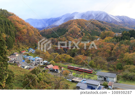 Aizu Railway with autumn leaves and snowy scenery Aizu Railway with autumn leaves and snowy scenery 108930287