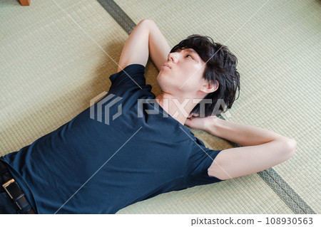 young man lying on tatami young man lying on tatami 108930563