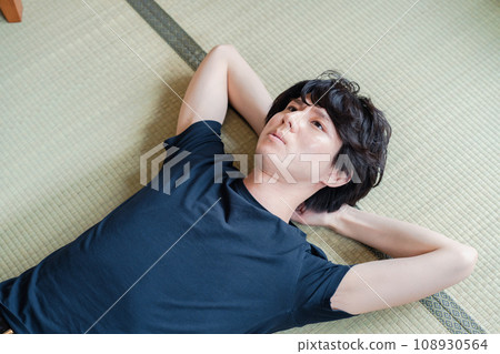 young man lying on tatami 108930564