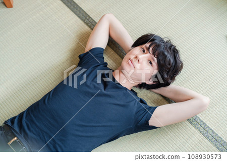 young man lying on tatami 108930573