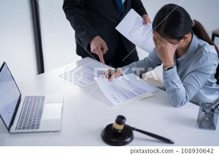 Businessman explaining about finance data to lawyer while female attorney reading business document and feeling stressed to analysis about legal agreement and terms of business contract in law firm Businessman explaining about finance data to lawyer while female attorney reading business document and feeling stressed to analysis about legal agreement and terms of business contract in law firm 108930642