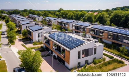 Eco-friendly apartment buildings with large solar panels on roofs surrounded by bright autumn trees Eco-friendly apartment buildings with large solar panels on roofs surrounded by bright autumn trees 108931322