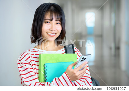 Female college student looking at smartphone Photography cooperation: Ariake College of Education and Arts 108931927