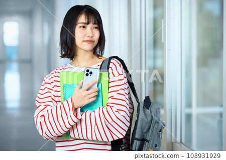 Female college student looking at smartphone Photography cooperation: Ariake College of Education and Arts 108931929