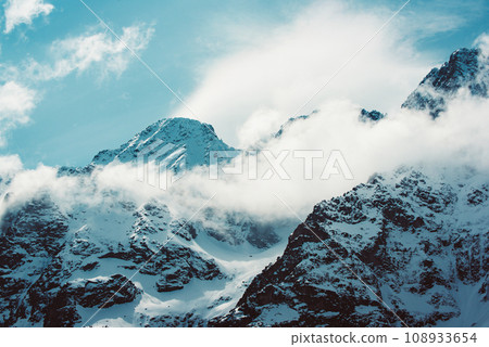 Mountain peaks near Morskie Oko or Sea Eye Lake in Poland at Winter. Tatras range Mountain peaks near Morskie Oko or Sea Eye Lake in Poland at Winter. Tatras range 108933654