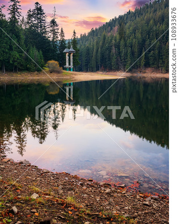 landscape of synevir lake at sunset in autumn. scenery reflecting in the water. popular travel destination of ukraine landscape of synevir lake at sunset in autumn. scenery reflecting in the water. popular travel destination of ukraine 108933676