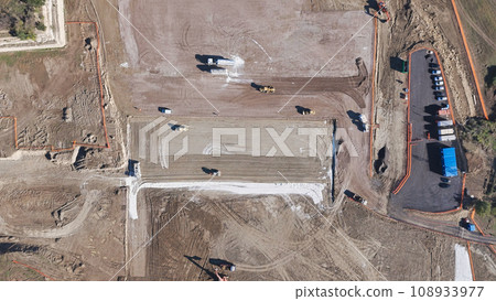 Earthmoving equipment. Aerial view of a large construction site with several earthmoving machines. Earthmoving equipment. Aerial view of a large construction site with several earthmoving machines. 108933977