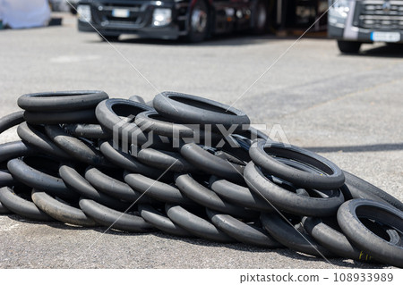 A Towering Stack of Rubber: A Pile of Tires in the Center of a Parking Lot A Towering Stack of Rubber: A Pile of Tires in the Center of a Parking Lot 108933989