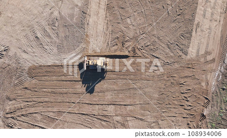 Earthmoving equipment. Aerial view of a large construction site with several earthmoving machines. Earthmoving equipment. Aerial view of a large construction site with several earthmoving machines. 108934006
