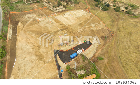 Earthmoving equipment. Aerial view of a large construction site with several earthmoving machines. Earthmoving equipment. Aerial view of a large construction site with several earthmoving machines. 108934062