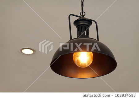 Vintage lamp hanging from the ceiling with white wall decorated in hotel Vintage lamp hanging from the ceiling with white wall decorated in hotel 108934583