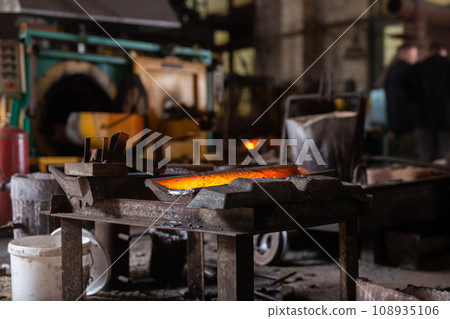 Mold with molten metal in the foundry workshop of metallurgical plant 108935106