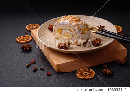 A piece of delicious sweet meringue roll with mascarpone cheese, berries and almonds 108935141