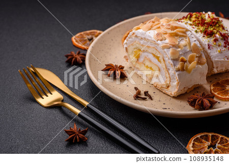 A piece of delicious sweet meringue roll with mascarpone cheese, berries and almonds A piece of delicious sweet meringue roll with mascarpone cheese, berries and almonds 108935148