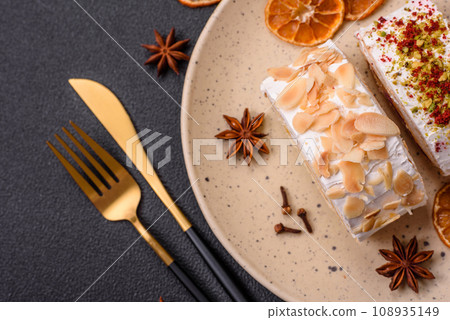 A piece of delicious sweet meringue roll with mascarpone cheese, berries and almonds A piece of delicious sweet meringue roll with mascarpone cheese, berries and almonds 108935149