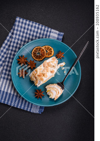 A piece of delicious sweet meringue roll with mascarpone cheese, berries and almonds A piece of delicious sweet meringue roll with mascarpone cheese, berries and almonds 108935162
