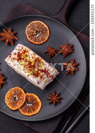 A piece of delicious sweet meringue roll with mascarpone cheese, berries and almonds 108935175