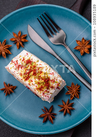 A piece of delicious sweet meringue roll with mascarpone cheese, berries and almonds A piece of delicious sweet meringue roll with mascarpone cheese, berries and almonds 108935189