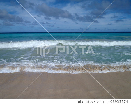 Dramatic wave sweeping away as another comes forward on a beach in Oahu, Hawaii Dramatic wave sweeping away as another comes forward on a beach in Oahu, Hawaii 108935574