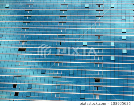 Blue Glass Windows reflect clouds and Sky 108935625