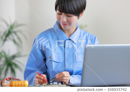 Female engineer inspecting the board with a measuring device 1 Female engineer inspecting the board with a measuring device 1 108935742
