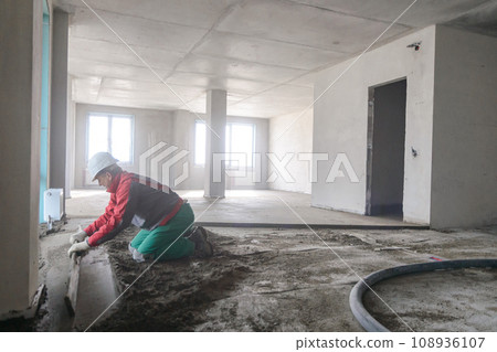 A builder in work clothes is doing his job A builder in work clothes is doing his job 108936107