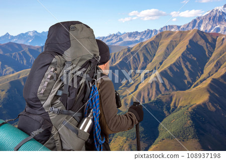 man traveler with hiking equipment on mountain landscape background. nature hikes in the mountains man traveler with hiking equipment on mountain landscape background. nature hikes in the mountains 108937198