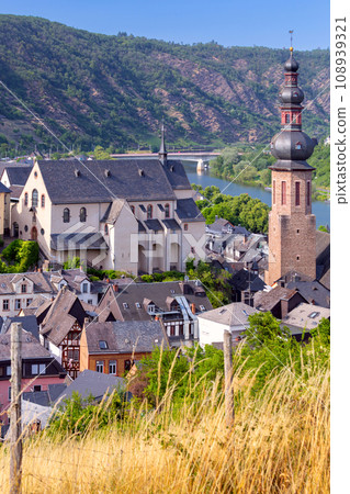 Scenic view of the old fairytale German town of Cochem and the valley on a sunny day. Germany. Scenic view of the old fairytale German town of Cochem and the valley on a sunny day. Germany. 108939321