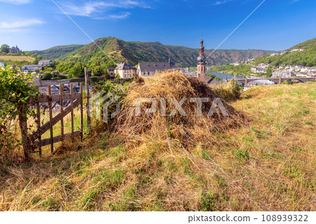Scenic view of the old fairytale German town of Cochem and the valley on a sunny day. Germany. Scenic view of the old fairytale German town of Cochem and the valley on a sunny day. Germany. 108939322