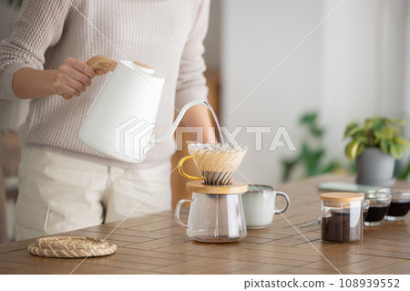woman making coffee in the room woman making coffee in the room 108939552
