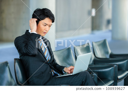 businessman sitting on chair in lobby 108939627