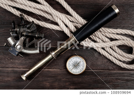 Retro vintage naval spyglass telescope with sextant and compass Retro vintage naval spyglass telescope with sextant and compass 108939694