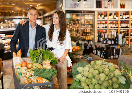 Couple shopping at vegetables department at supermarket Couple shopping at vegetables department at supermarket 108940106