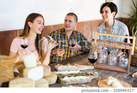 Cheerful people tasting artisanal goat cheese at Spanish farm Cheerful people tasting artisanal goat cheese at Spanish farm 108940327