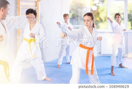 Group of children train karate techniques 108940629