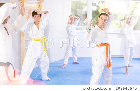 Group of children train karate techniques 108940679