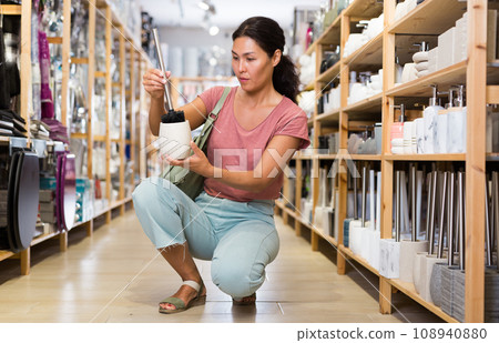 Woman choosing toilet brush 108940880