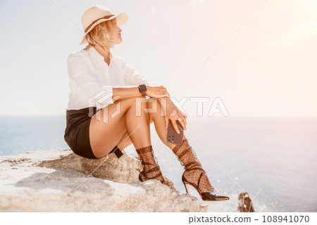 Woman sea laptop. Business woman in yellow hat freelancer with laptop working over blue sea beach. Girl relieves stress from work. Freelance, digital nomad, travel and holidays concept Woman sea laptop. Business woman in yellow hat freelancer with laptop working over blue sea beach. Girl relieves stress from work. Freelance, digital nomad, travel and holidays concept 108941070