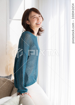 A young woman relaxing in the room A young woman relaxing in the room 108941654