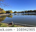People enjoying fishing in the park where the leaves have started to turn autumn 108942905