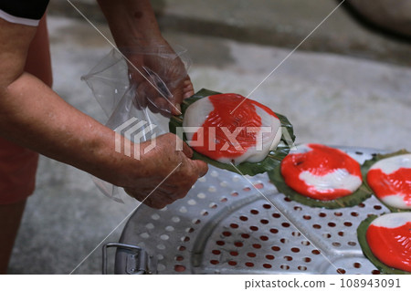 老婦人正在製作傳統的紅龜粿 老婦人正在製作傳統的紅龜粿 108943091