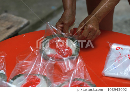 老婦人正在製作傳統的紅龜粿 老婦人正在製作傳統的紅龜粿 108943092