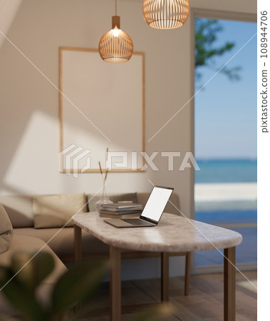 Comfortable cozy minimal living room with beige sofa and coffee table near large window with laptop computer. Comfortable cozy minimal living room with beige sofa and coffee table near large window with laptop computer. 108944706