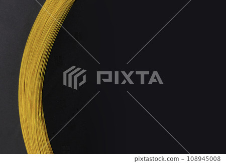 Festive gold braid on black background Festive gold braid on black background 108945008