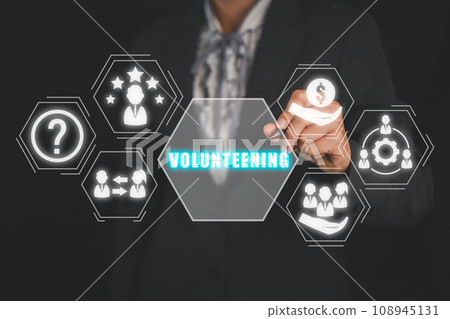 Volunteening concept, Businesswoman hand touching volunteening icon on virtual screen. Volunteening concept, Businesswoman hand touching volunteening icon on virtual screen. 108945131