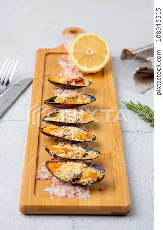 oysters scallops with red sea salt and citric acid on a wooden tray oysters scallops with red sea salt and citric acid on a wooden tray 108945515