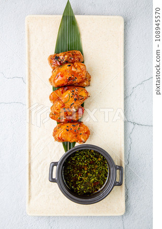 Slices of pike perch in sweet and sour sauce on a banana leaf top view 108945570