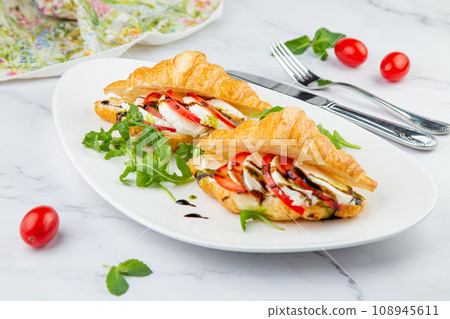 croissants with cheese, vegetables, cherry tomatoes and herbs 108945611